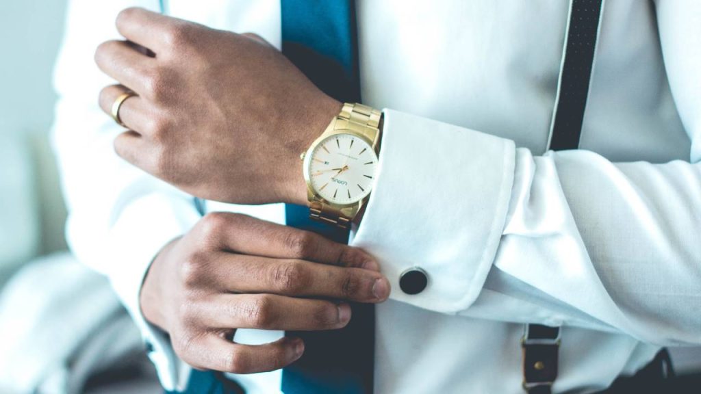 Closeup photo of a businessman's golden watch on his wrist